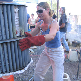woman opening raku hat kiln uvapapa Villa Grove San Luis Valley Colorado pottery fireweed studio jenn weede